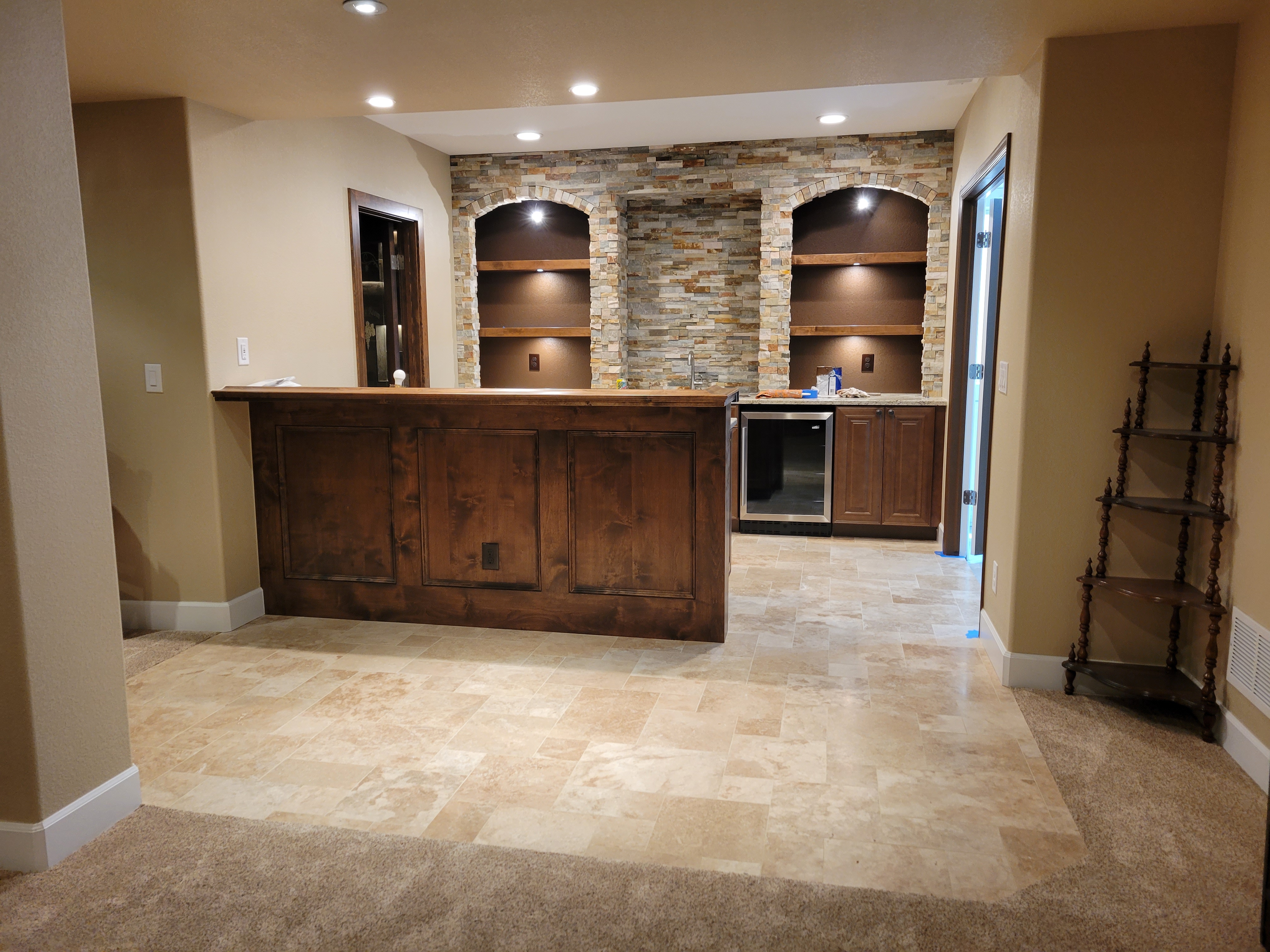 Travertine Floor and Split-face Stone Bar Backsplash